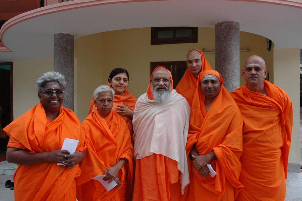 Newly-ordained sannyasis with a senior guru figure at the center, around the time of Swamiji's own sannyasa